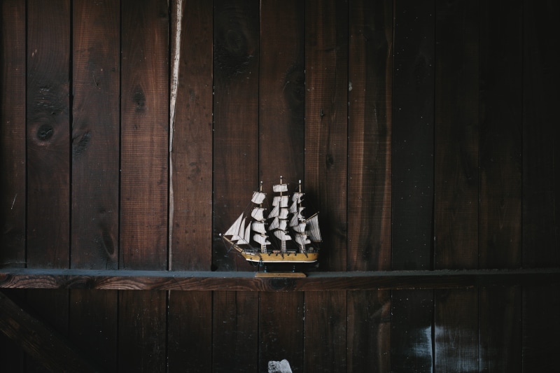 wall - building feature, indoors, place of worship, old-fashioned, shelf, sailboat, close-up, built structure, model, toy boat, ship, galleon, architecture
