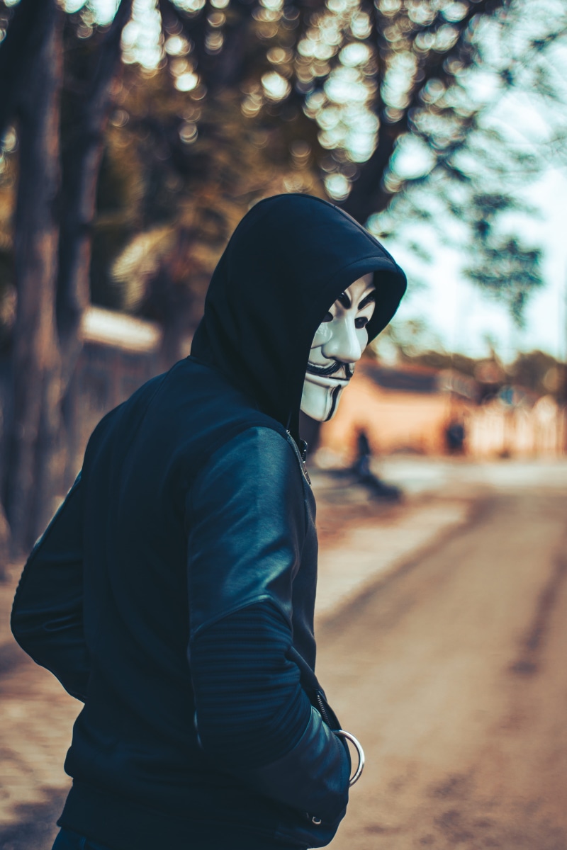 facial expression, hood - clothing, men, tree, clothing, hooded shirt, wearing, looking, face mask, leisure activity, urban, hoodie, horror, road, model
