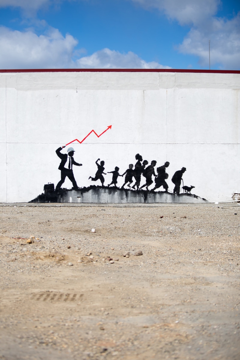 group of people, business, people, street art, day, group, sitting, men, transportation, water, cloud - sky, medium group of people, concrete, Banksy, sky
