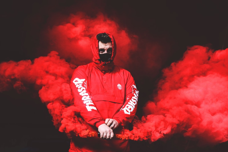 one person, helmet, hoodie, red, front view, wearing, sport, baseball player, angst, headwear, waist up, baseball uniform, ominous, urban explorer, indoors