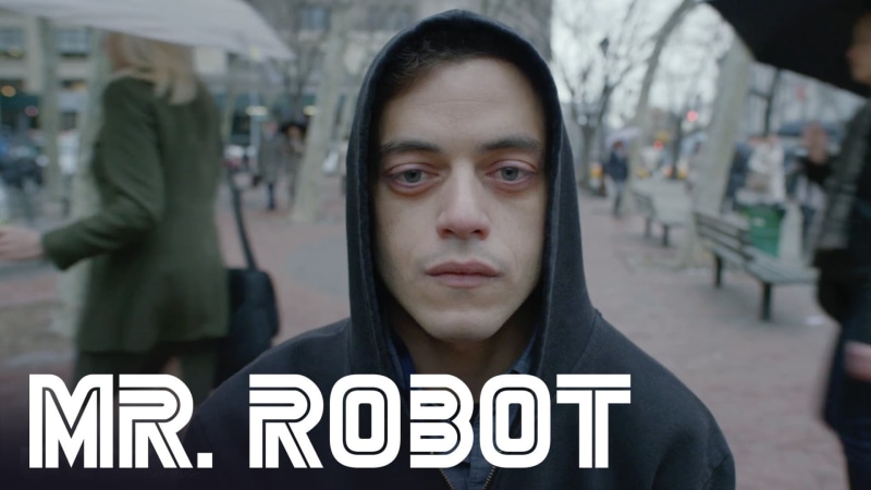 focus on foreground, young adult, man, front view, real people, hood - clothing, hoodie, casual clothing, city, text, hacking, architecture, one person