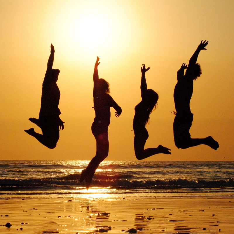 orange color, jumping, happiness, performance, together, dancing, celebration, joy, ocean, motion, back lit, people, beach, four, vacation, 2K, outdoors
