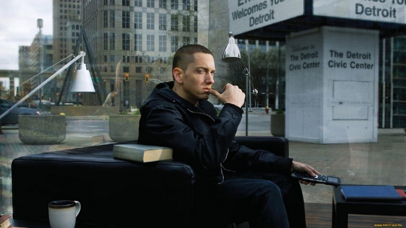 seat, glass - material, adult, city, one person, Eminem, Singers, contemplation, young adult, chair, looking, building exterior, built structure, sitting