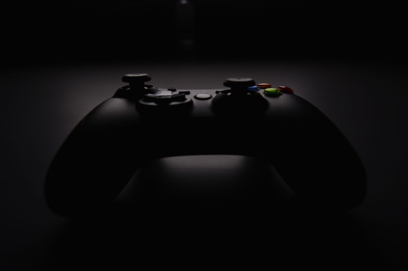 gamer, studio shot, human body part, illuminated, black, equipment, night, black background, wireless, objects/Equipment, spotlight, joystick, technology