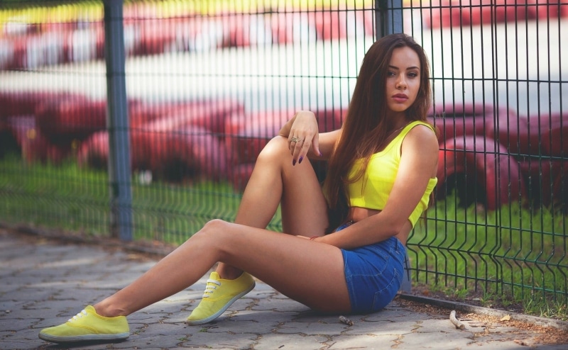 lifestyles, real people, sneakers, front view, long hair, fence, portrait, day, outdoors, boundary, beautiful woman, young adult, 1080P, hairstyle, shorts