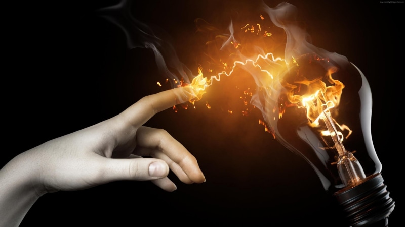 orange color, flame, light, heat, heat - temperature, black background, glowing, darkness, body part, one person, bonfire, holding, human body part, smoke
