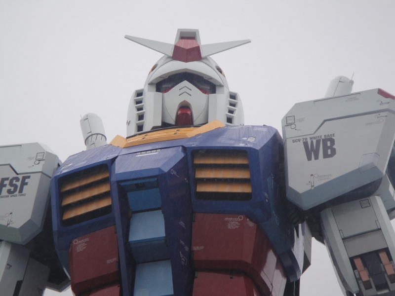 building exterior, outdoors, RX-78 Gundam, Japan, sign, communication, built structure, day, mode of transportation, architecture, illustration, nature