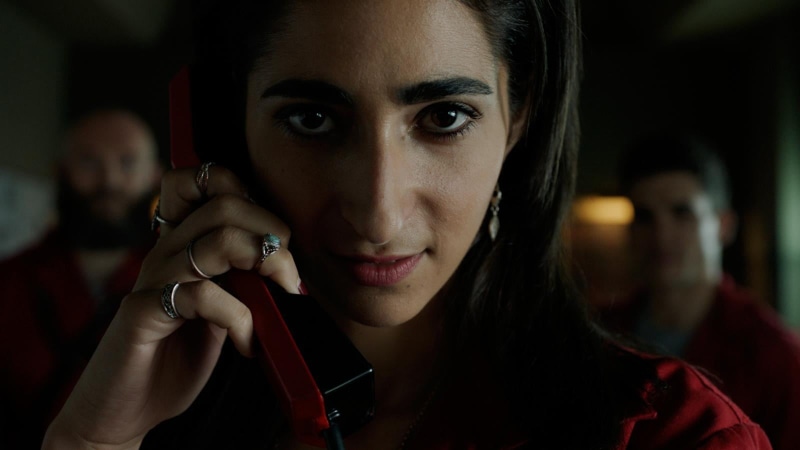one person, headshot, close-up, beautiful woman, indoors, portrait, young adult, communication, emotion, red, tv series, holding, shirt, looking at camera