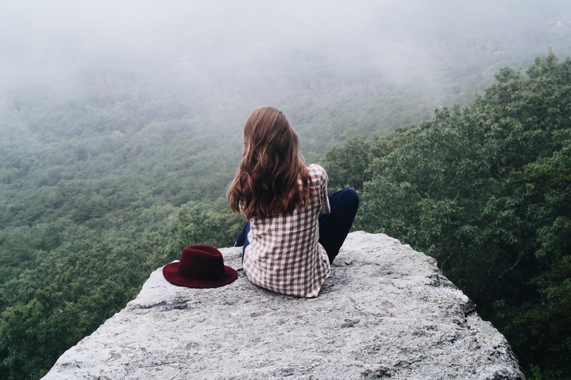 trees, adventure, beauty in nature, solid, rear view, girl, fog, leisure activity, lifestyles, one woman only, outdoors, rock, brunette, looking at view