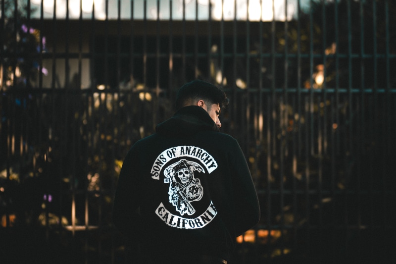 people, standing, rear view, city, day, clothing, real people, caucasian, text, indoors, fence, men, night, one man only, man, white, one person, lifestyles