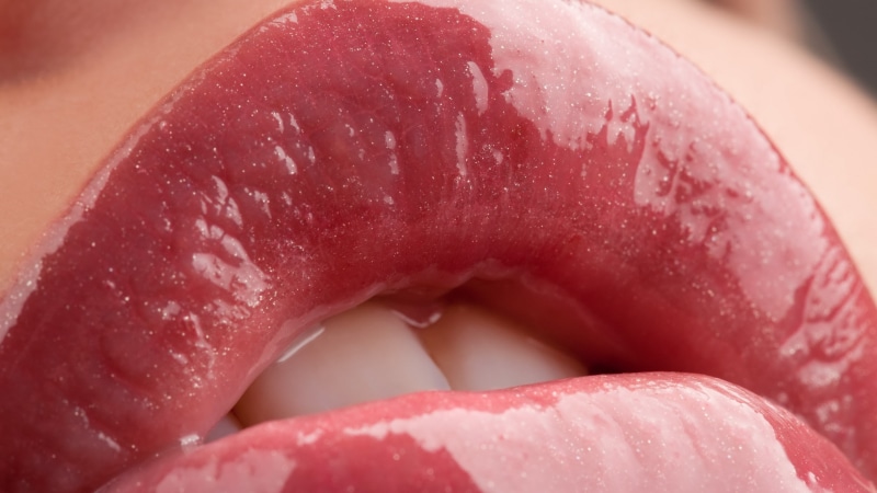 one person, human body part, 2K, human mouth, mouth open, close-up, wet, food, women, teeth, pink color, closeup, sweet food, extreme close-up, focus on foreground