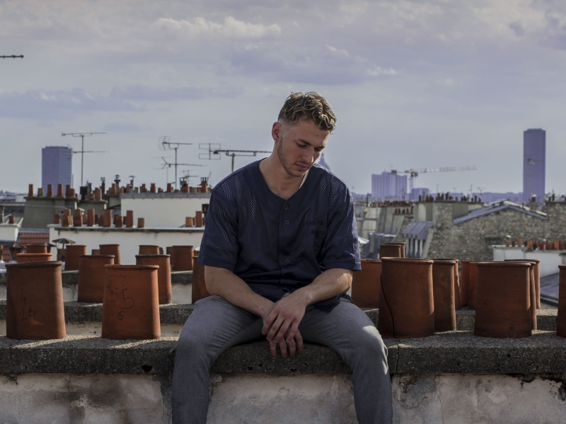 sit, building exterior, built structure, cloud - sky, teenager, city, man, rooftop, adolescence, leisure activity, casual clothing, portrait, guy, sitting