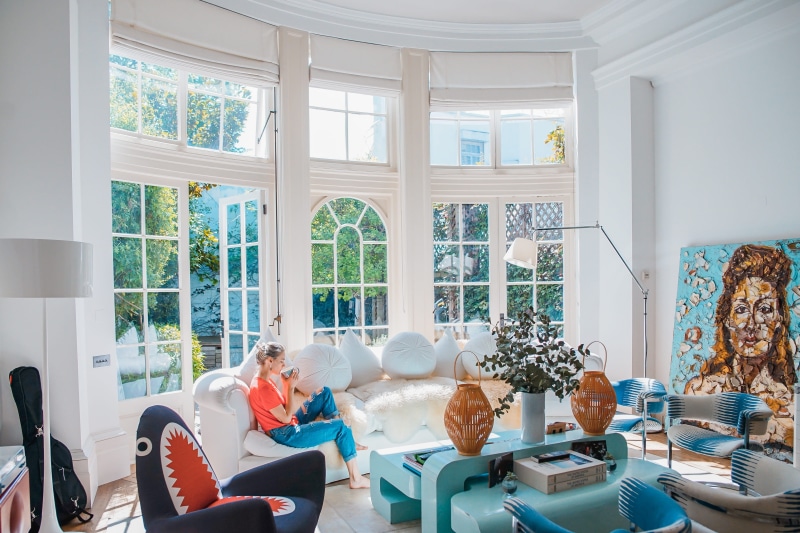 interior, day, chair, indoors, blue, men, women, couch, home interior, people, daytime, adult, woman, window, art, white, seat, lifestyles, top, house