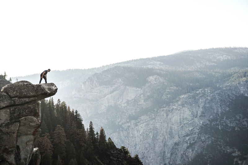 sky, wearing, men, scenics - nature, shirt, man, activity, outdoors, hiking, day, looking, edge, ledge, mountain, rock, forest, nature, real people, leisure activity