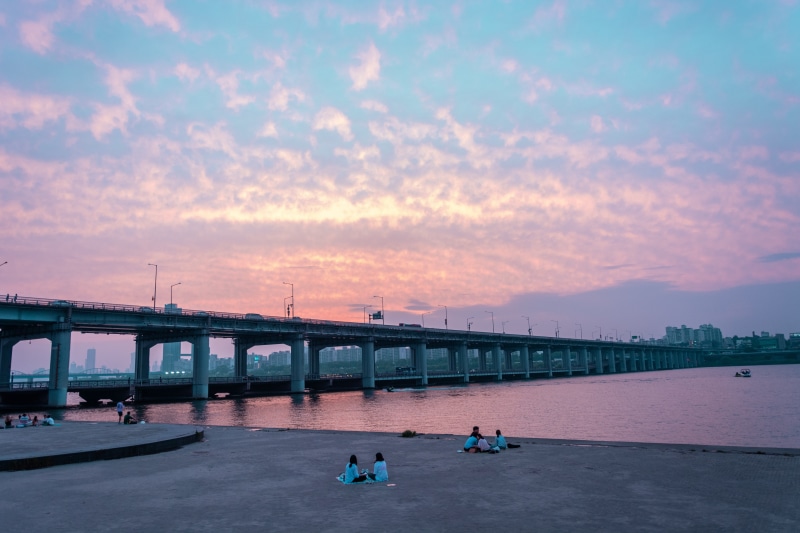 engineering, tourism, lifestyles, architectural column, cloud - sky, sunset, transportation, korea, real people, eastern, traditional, large group of people