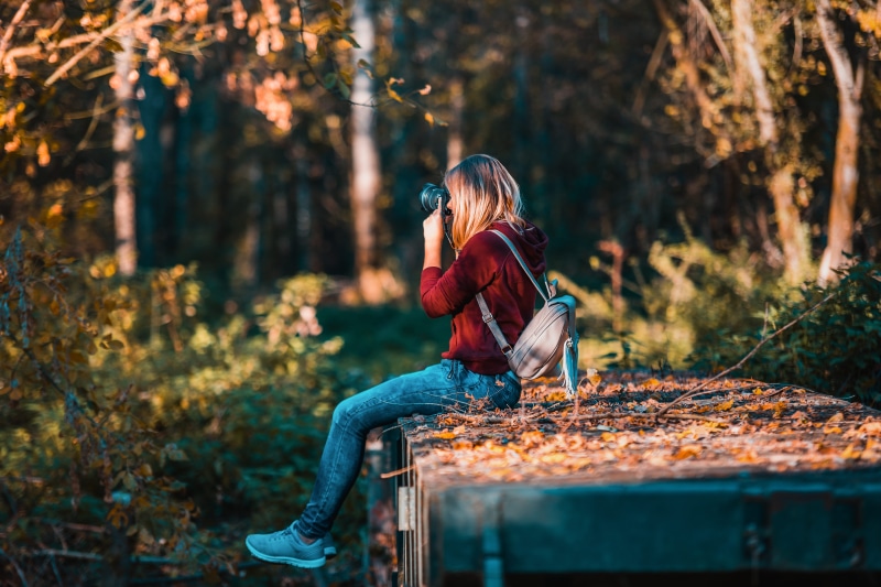 hobby, happiness, person, forest, lifestyle, daylight, activity, casual clothing, photographer, recreation, camera, females, woods, fall, tree, backpacker