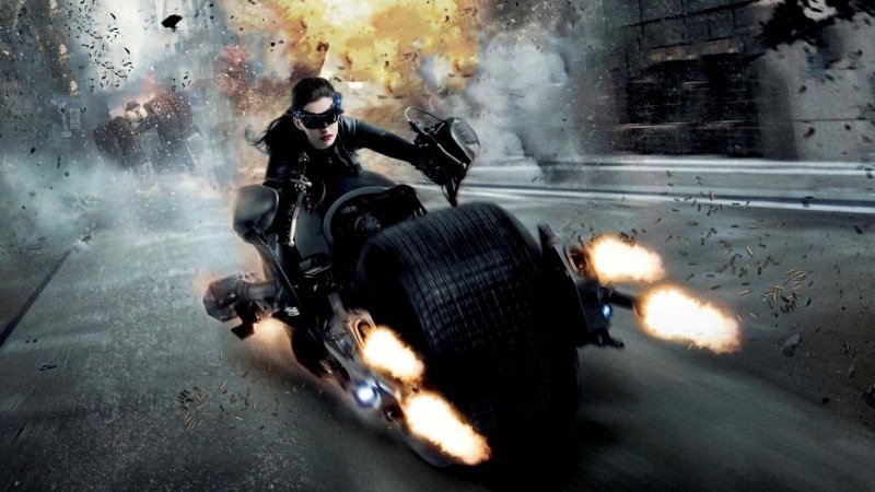 motion, holding, one person, Selina Kyle, communication, transportation, sign, sitting, city, real people, warning sign, full length, young adult, The Dark Knight Rises