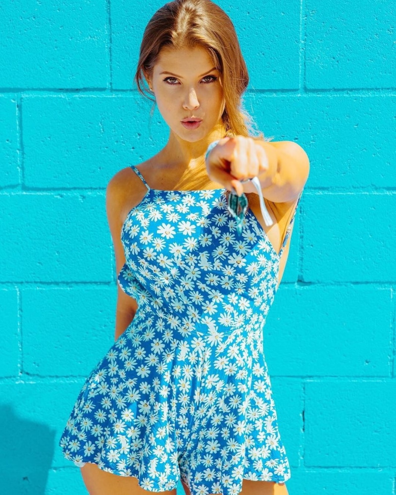 portrait, looking at viewer, turquoise colored, beautiful woman, brick wall, fashion, adult, standing, one person, wall - building feature, floral pattern
