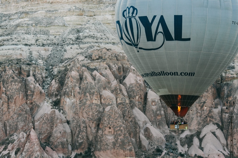 balloon, hot Air Balloon, blue Royal, building exterior, 2K, western script, flying, no people, communication, cappadocia, travel destinations, outdoors