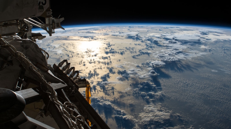 space, Pacific Ocean, air vehicle, outdoors, ISS, cloud - sky, high angle view, day, planet earth, flying, environment, scenics - nature, sky, digital composite