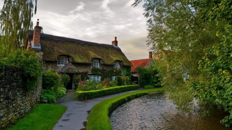 road, clouds, wet, stone house, 1080P, wall, sidewalks, stones, nature, architecture, grass, plants, house, trees, chimneys, street, flowers, village