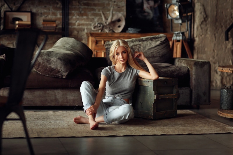 couch, looking at viewer, on the floor, barefoot, women indoors, Dmitry Arhar, Katerina Shiryaeva, portrait, blonde, 1080P, sitting, tiptoe, grey shirt