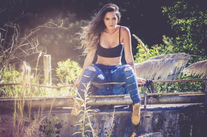 model, plant, day, sitting, tree, young adult, adult, outdoors, land, hairstyle, nature, front view, women outdoors, one person, young women, casual clothing