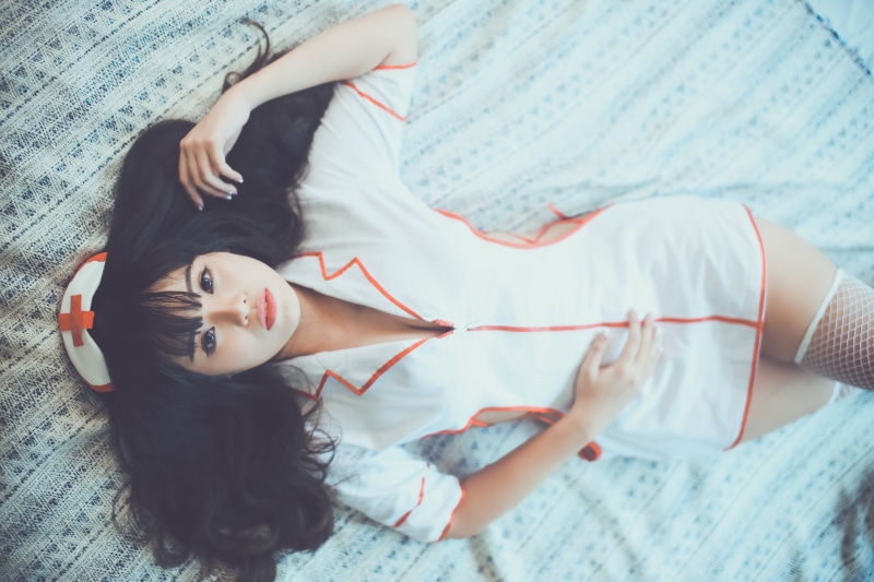 leisure activity, lying down, lifestyles, full length, uniform, textile, woman, only women, bed, female, one person, real people, one young woman only