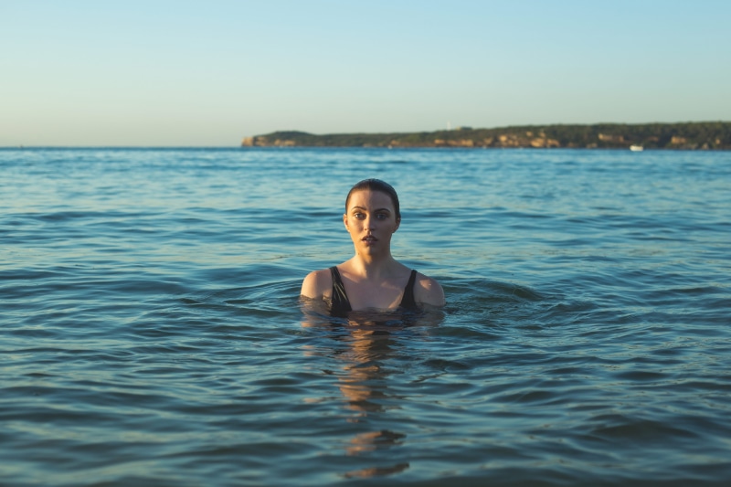wearing, one woman only, outdoors, young adult, lifestyles, reflection, leisure activity, ocean, headshot, adults only, daytime, real people, front view