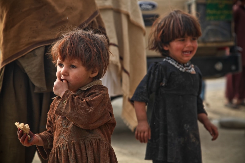 focus on foreground, outdoors, dresses, girls, childhood, war, boys, cute, real people, color Image, bangs, crying, family, fear, daytime, children, two