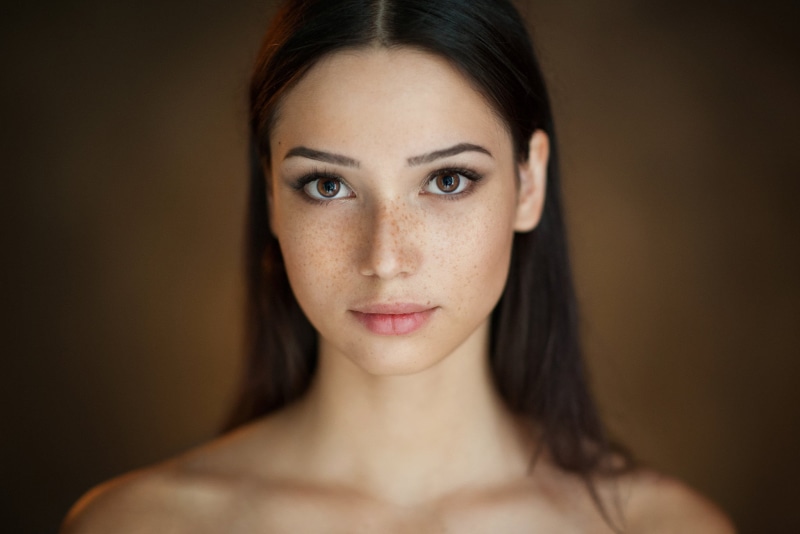 contemplation, hair, close-up, brown eyes, freckles, human body part, portrait, studio shot, headshot, beautiful woman, one person, hairstyle, body part