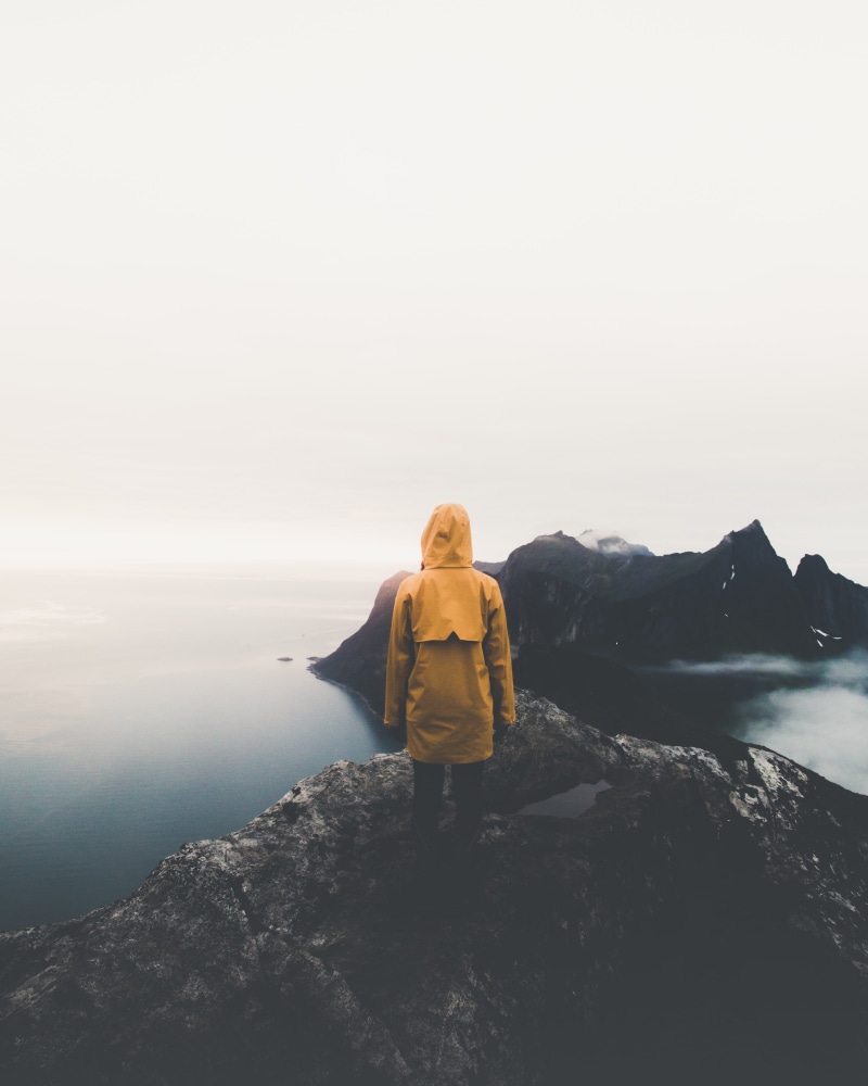 solitude, mountain, yellow, fog, outdoors, norway, leisure activity, sea, solid, loneliness, vacations, copy space, one person, hood, looking at view, sky