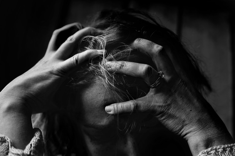 body part, unhappy, one person, close-up, sadness, black and white, black background, person, expression, hopelessness, indoors, focus on foreground, female