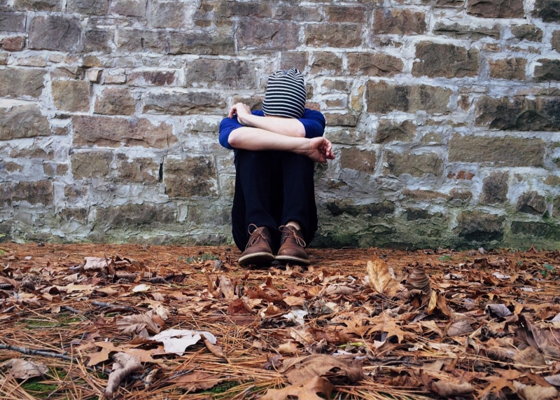 brown, real people, alone, one person, top, sad, loneliness, casual clothing, standing, wall - building feature, person, pants, day, wearing, women, change