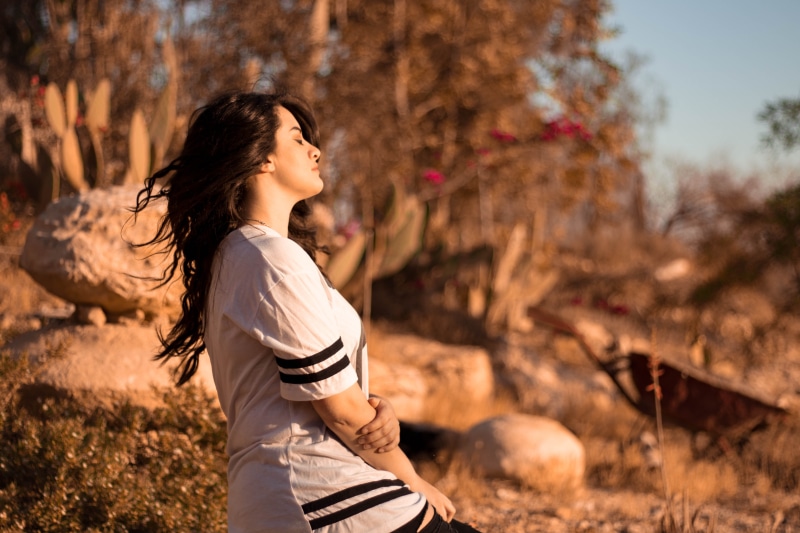 happy, adults only, long hair, vacation, woman, rocks, dom, sky, casual clothing, mid adult, healthy, adult, beach, relaxing, standing, women, outdoors