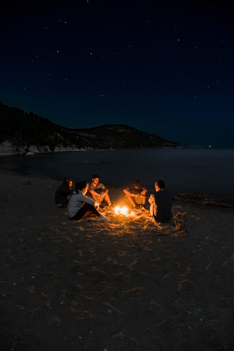 flame, shore, togetherness, people, night, real people, leisure activity, near, group of people, nature, bay, water, heat - temperature, nighttime, fire - natural phenomenon