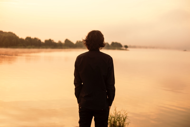 water, sunset, walking, daytime, copy Space, one Person, guy, lifestyles, sun, sea, silhouette, adults only, looking at view, outdoors, beach, landscape