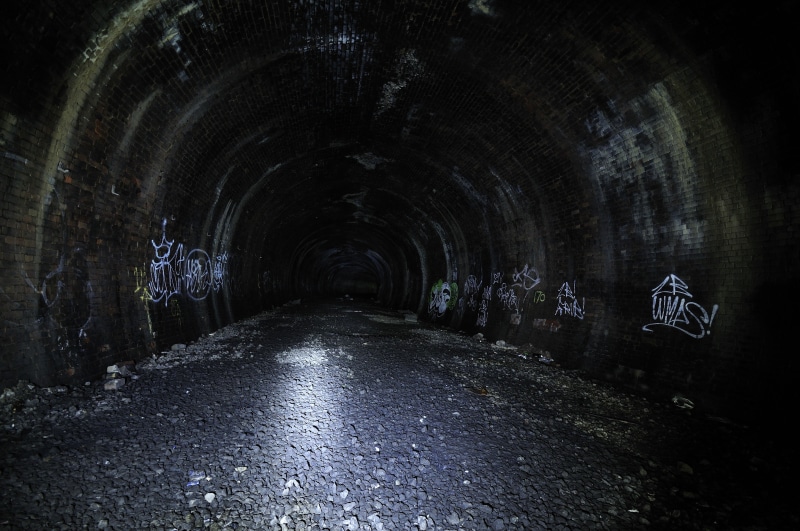 nature, arch, indoors, diminishing perspective, ceiling, built structure, transportation, no people, dark, concrete, footpath, night, graffiti, wet, long