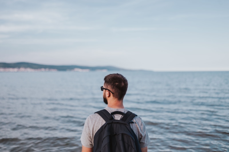 trip, waist up, nature, looking at view, young, natural Phenomenon, backpack, male, copy Space, young men, horizon over water, outdoors, sunny beach, sea