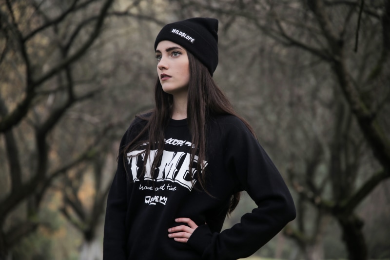 beautiful woman, young, teenager, plant, black, sweater, facial expression, youth, black color, pose, photoshoot, one person, focus on foreground, nature
