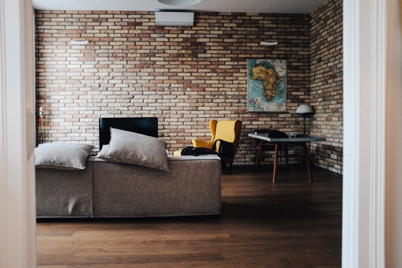 furniture, pillow, gray, home showcase interior, seat, lifestyles, cozy, brick, wood, decor, living room, interior, luxury, home, comfortable, fabric, wall