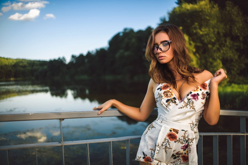 plunging, depth of field, women outdoors, trees, red, floral, nature, casual clothing, hair, necklace, front view, model, lake, standing, glasses, women with glasses