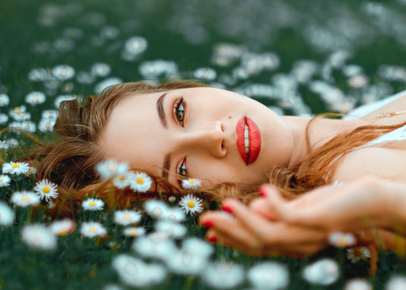 Saulius Ke, women outdoors, 1080P, depth of field, looking at viewer, portrait, red lipstick, model, women, flowers, on the floor, face, lying on back