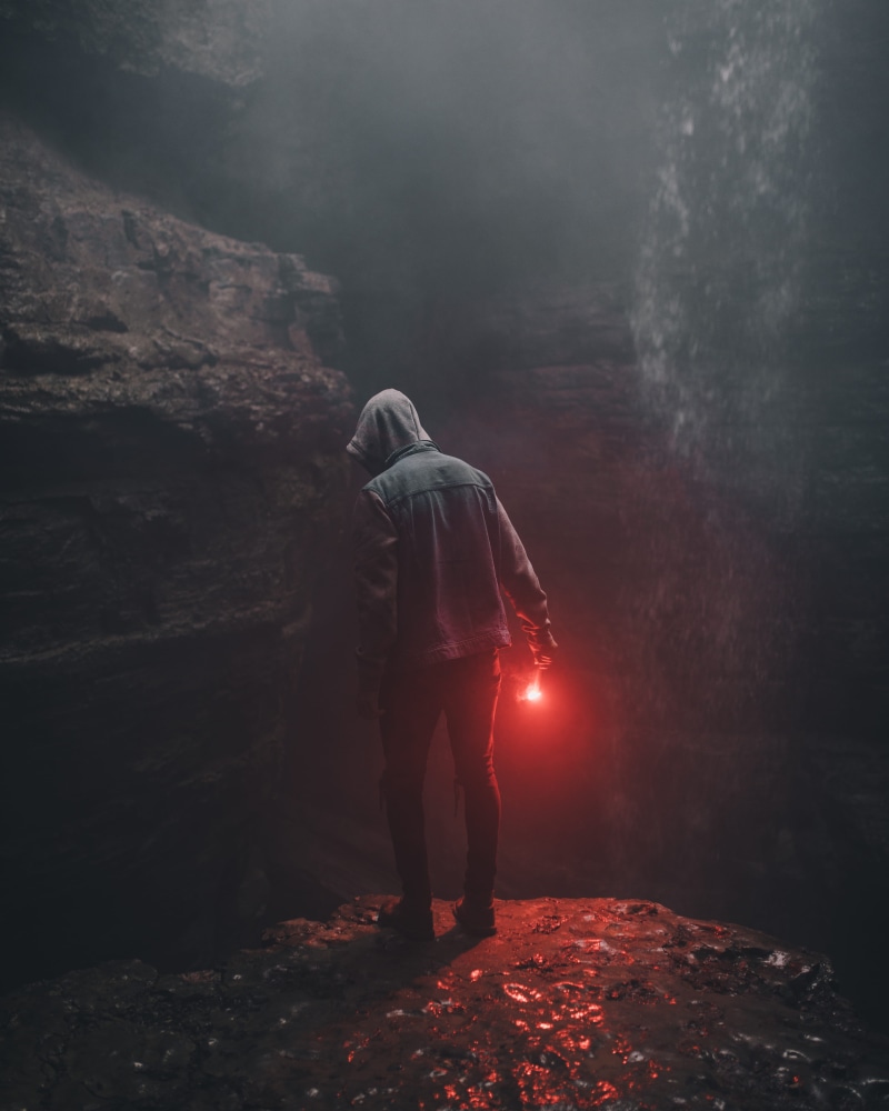flame, real people, hand, smoke - physical structure, flare, adult, hood - clothing, underground, right, red, solid, guy, light, young adult, rear view