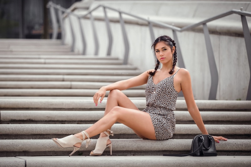 real people, staircase, sitting, legs, hair, focus on foreground, dress, one person, 1080P, outdoors, adult, young adult, hairstyle, fashion, portrait