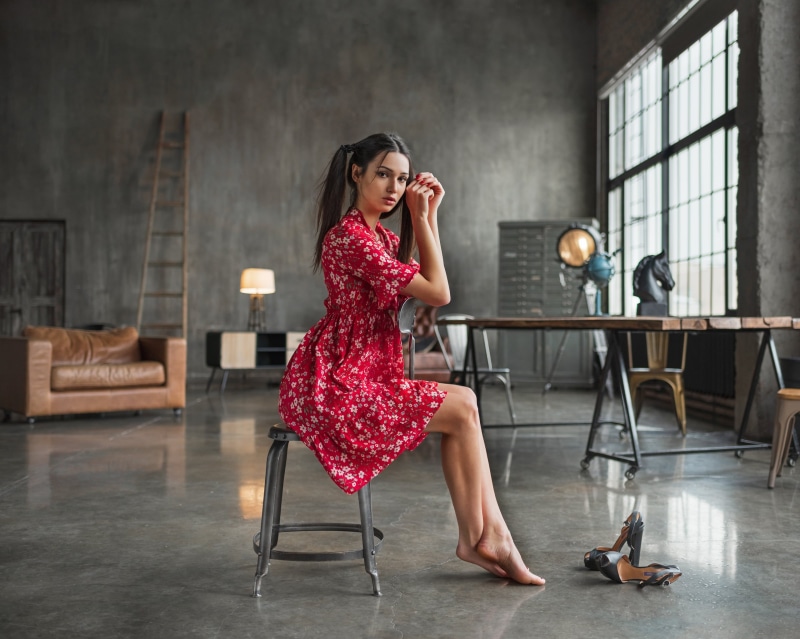 looking at viewer, model, red nails, painted nails, red dress, dress, brown eyes, women, indoors, pigtails, couch, side view, 2K, chair, depth of field