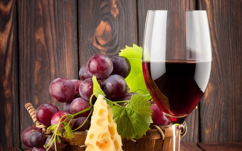 red wine, wood - material, wineglass, freshness, fruit, refreshment, indoors, grapes, drink, household equipment, food and drink, no people, food, table