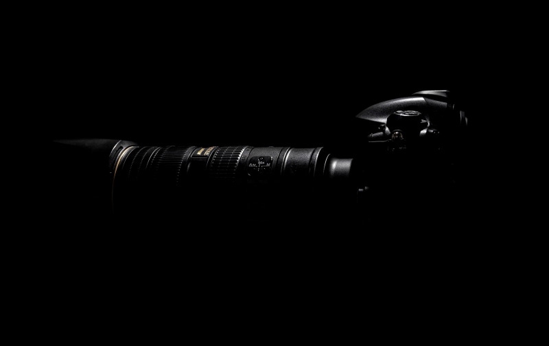 photography themes, black background, nikon camera, view, safety, darkness, representation, close-up, photo, camera equipment, security, top, people, side view