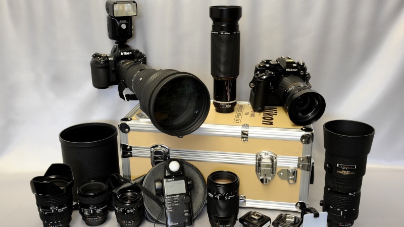 home video camera, indoors, black color, table, lens, high angle view, black, close-up, no people, two, cameras, film industry, photographic equipment