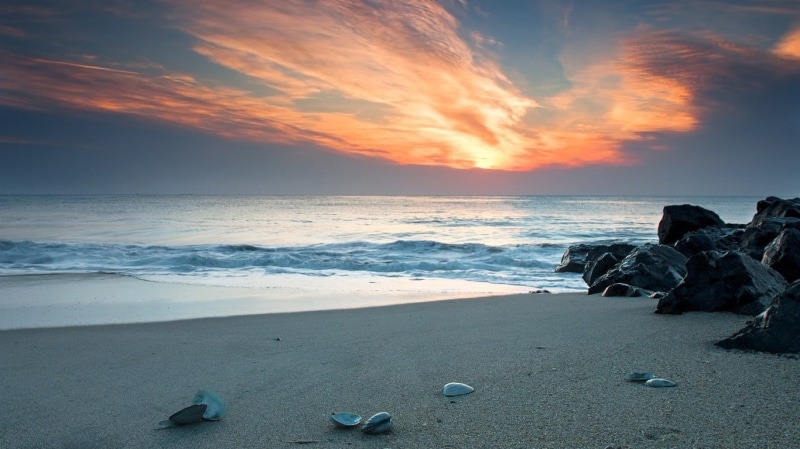 view, horizon over water, water, cloud - sky, sunset, sky, solid, seashore, angle, beach, aquatic sport, low, wave, motion, nature, beauty in nature, rock - object